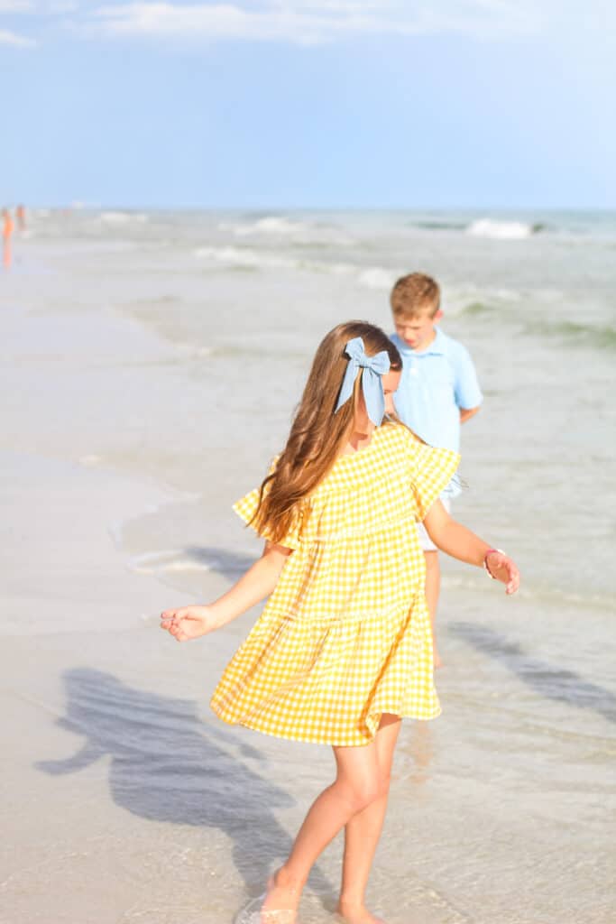 10 year old girl and boy on beach 