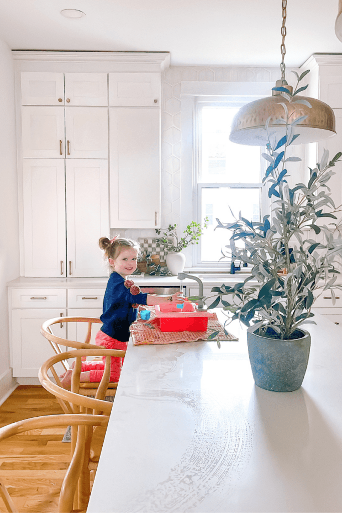 girl playing with toy sink 