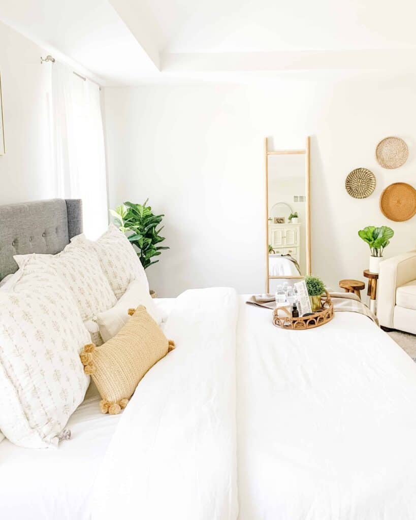 White bedroom with clean lines, natural wood details, and lots of light and greenery.