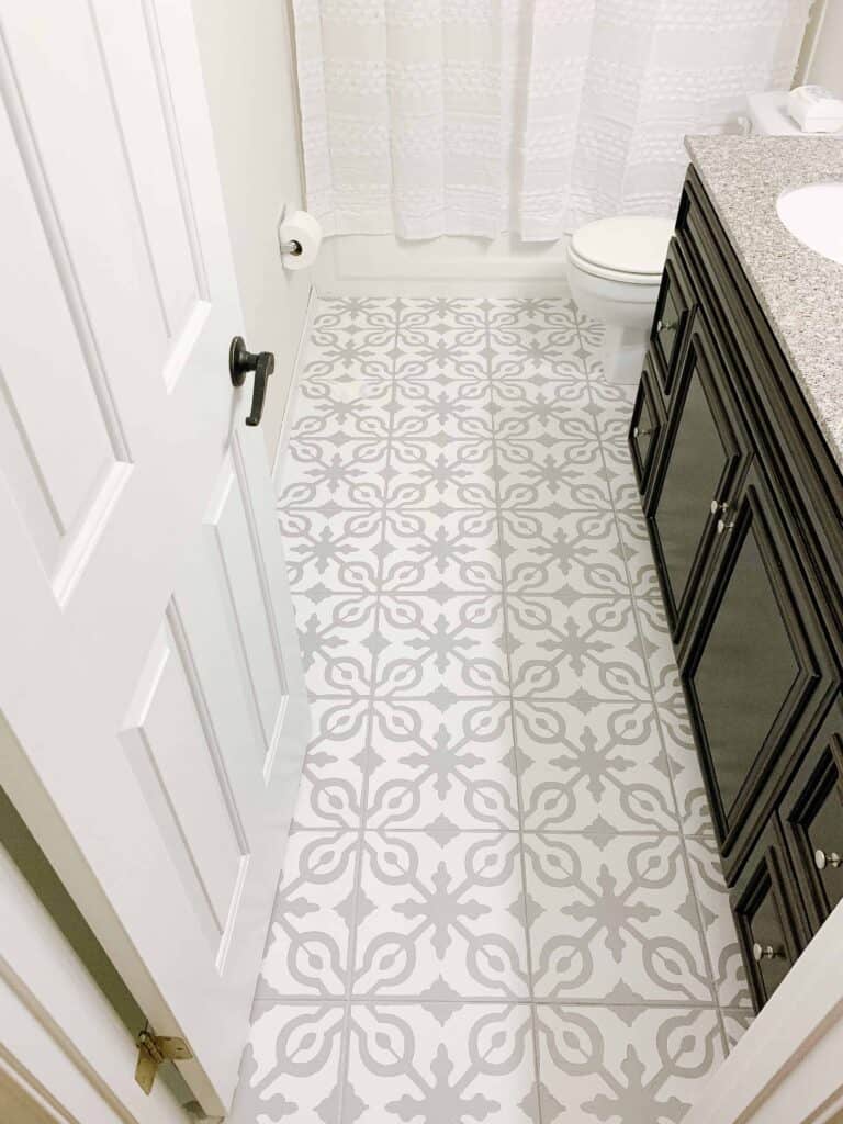 Bathroom with DIY stenciled painted tile floors.