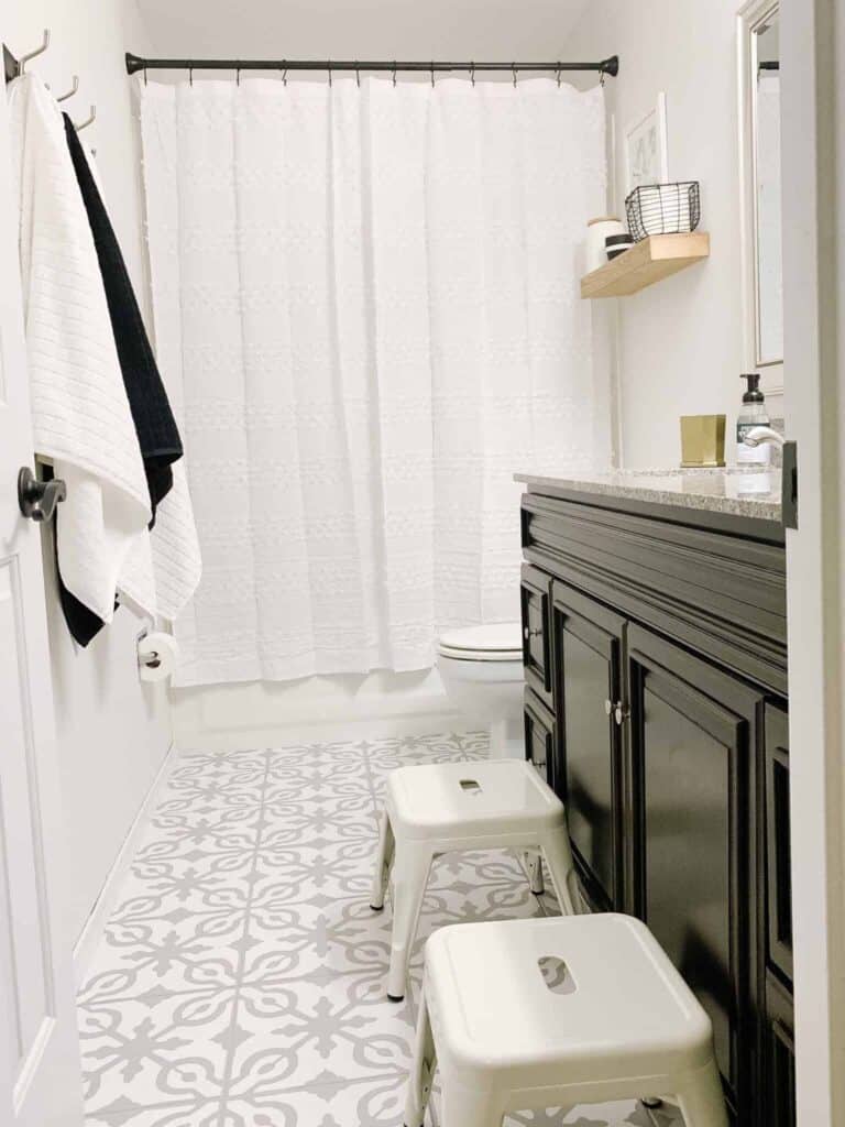 Bathroom with painted stencil tile floor.