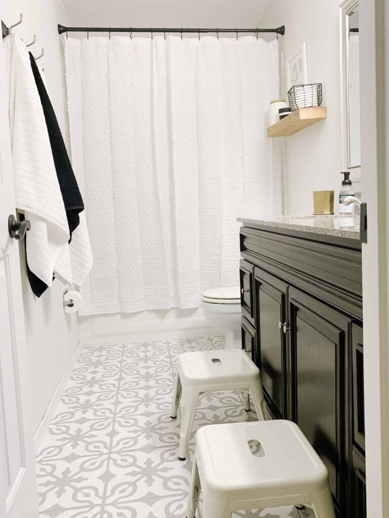 Bathroom with white shower curtain.