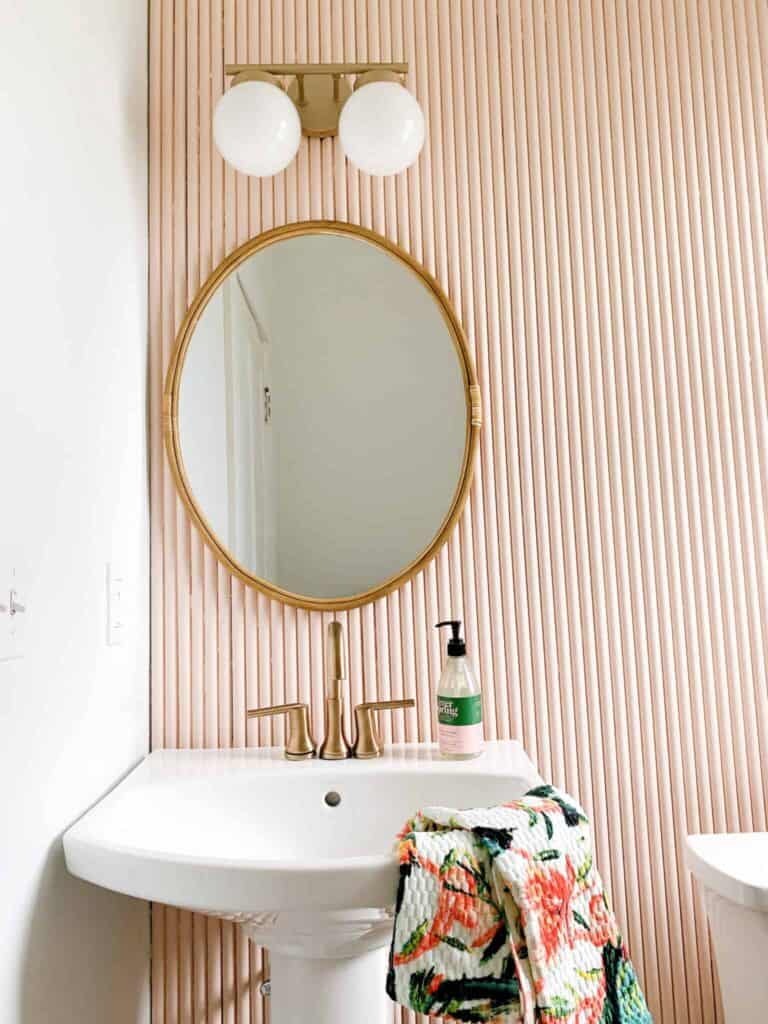 Pink bathroom with a pedestal sink.