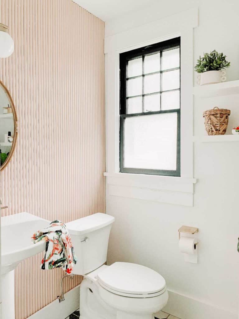 Pink bathroom with a pedestal sink.