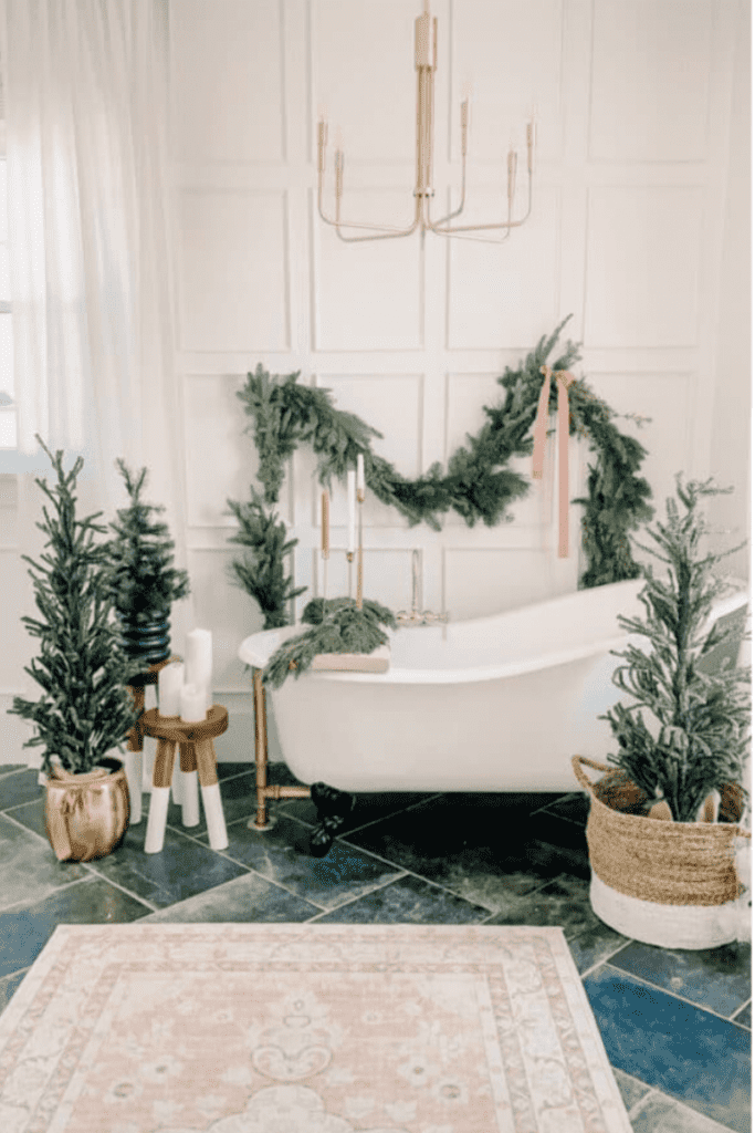 Clawfoot tub bathroom with decorative Christmas items and hanging garland.