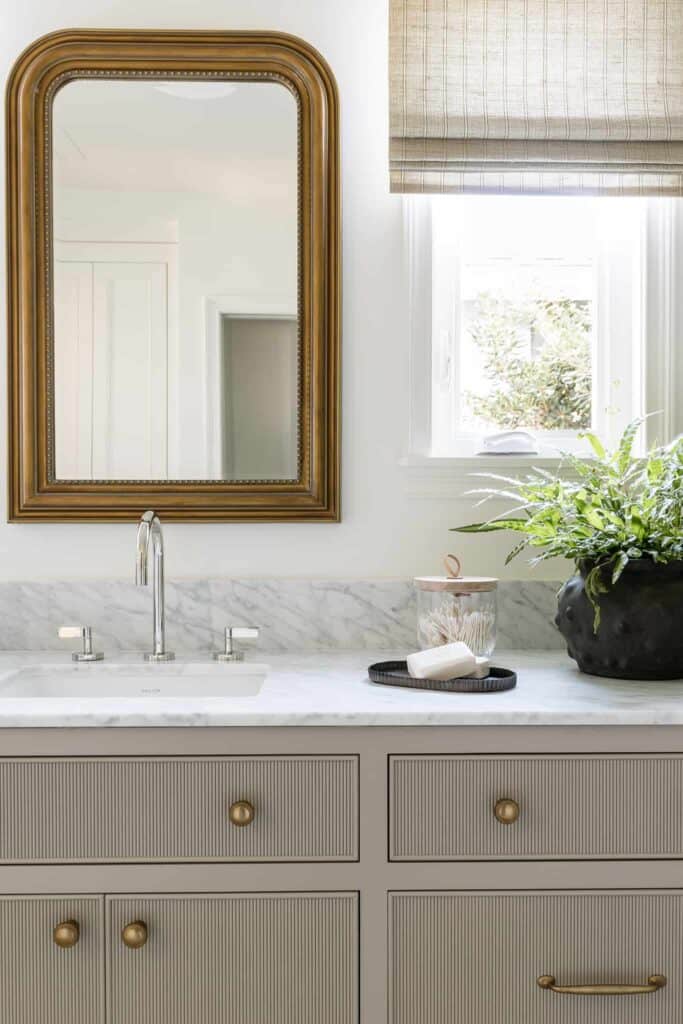 Mixed metals are used in this bathroom with brass and silver.