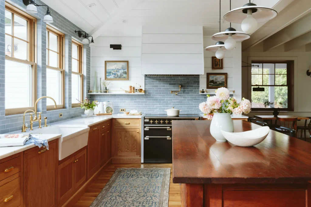 Kitchen with natural wood, blue backsplash, and vintage apron sink.