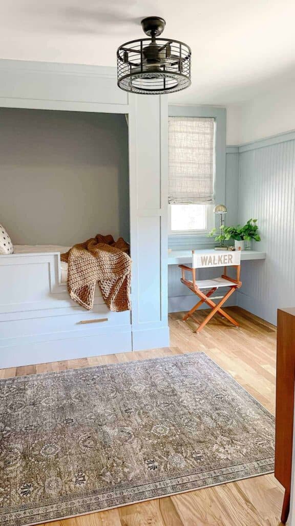 Boys room with blue paint color, custom built bed, and custom built desk.
