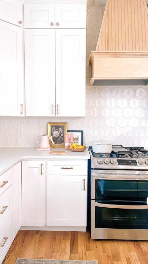 Corner of kitchen with close up of stove and hood.