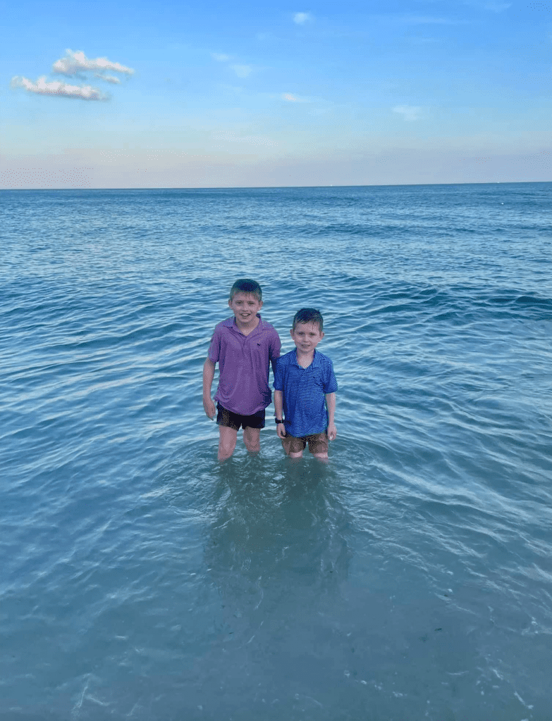 Boys in front of ocean