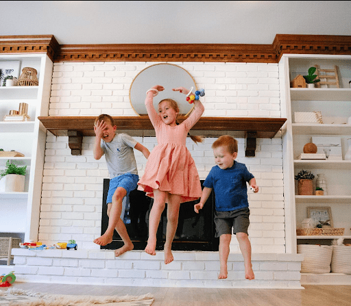 3 kids jumping in the air.