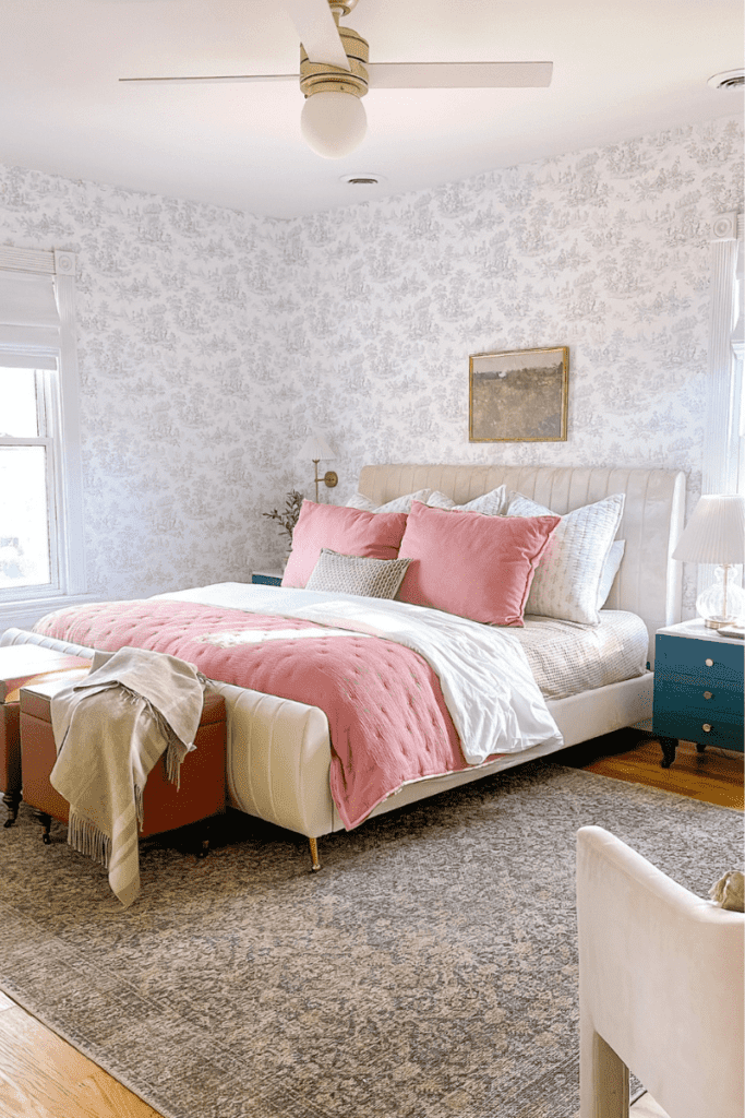 Master bedroom with neutral wallpaper in a french toile wallpaper.