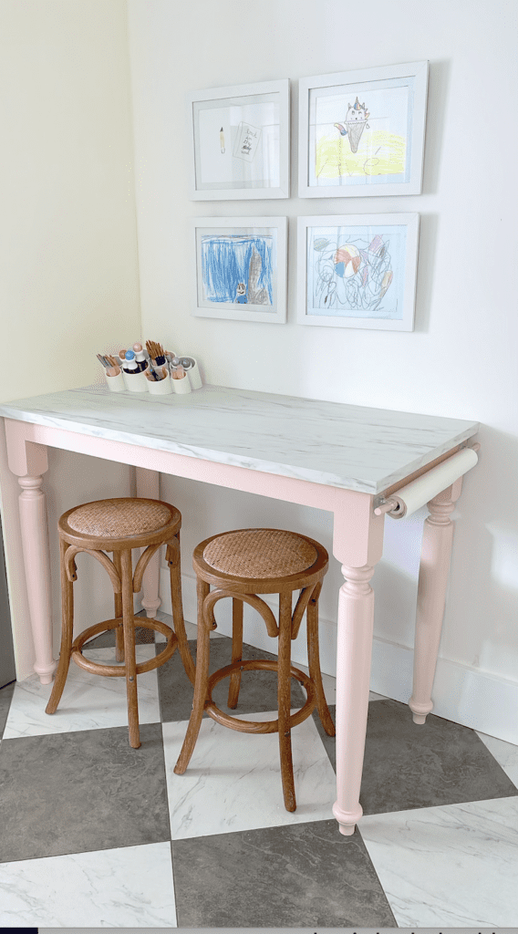 DIY art table with art easel and frames that are easily changed out for your kid's artwork.