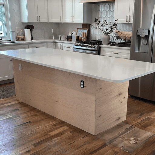 Kitchen island in the process of renovation with white countertop and MDF board.