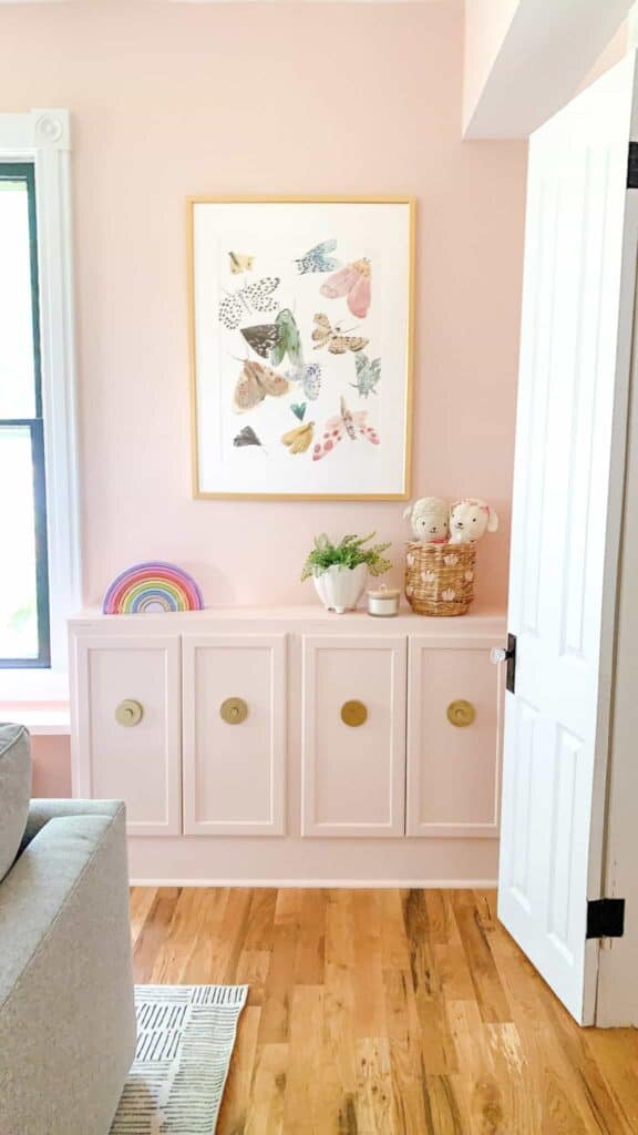 Butterfly poster in pink playroom with pink cabinets