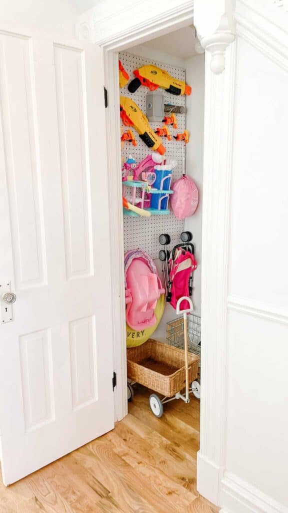 A peg board is a great option to store toys like these strollers, nerf guns, and doll accessories.
