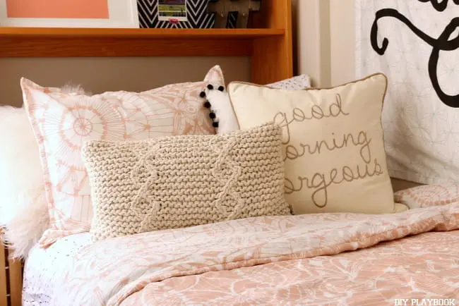 Cozy and girly college dorm room with pink bedding.