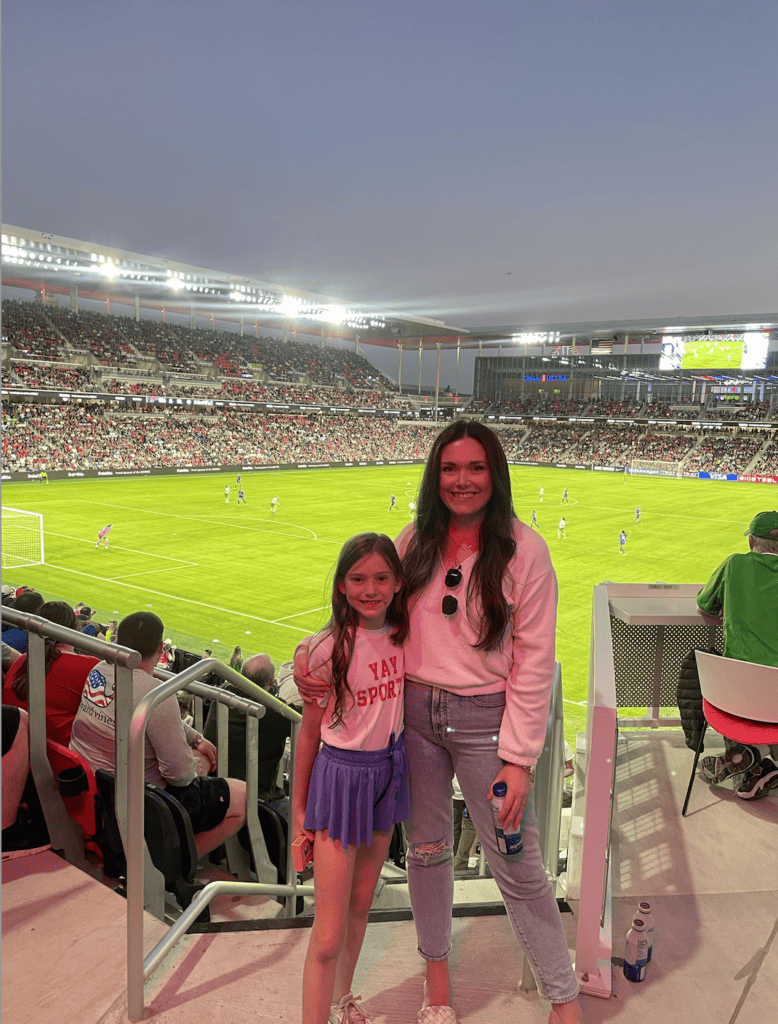 Mom and daughter at a soccer game.