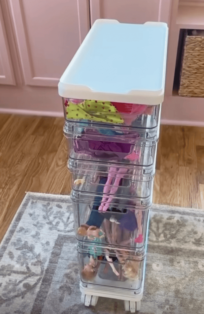 Barbies stored in a rolling cart.