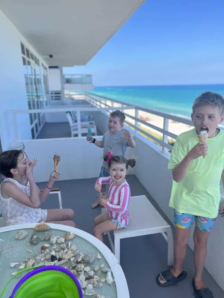Kids eating ice cream on a patio overlooking ocean