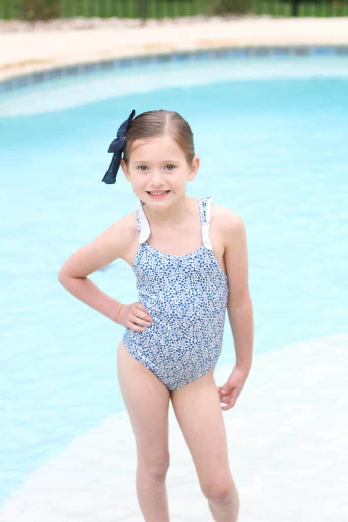 Little girl in blue swimsuit
