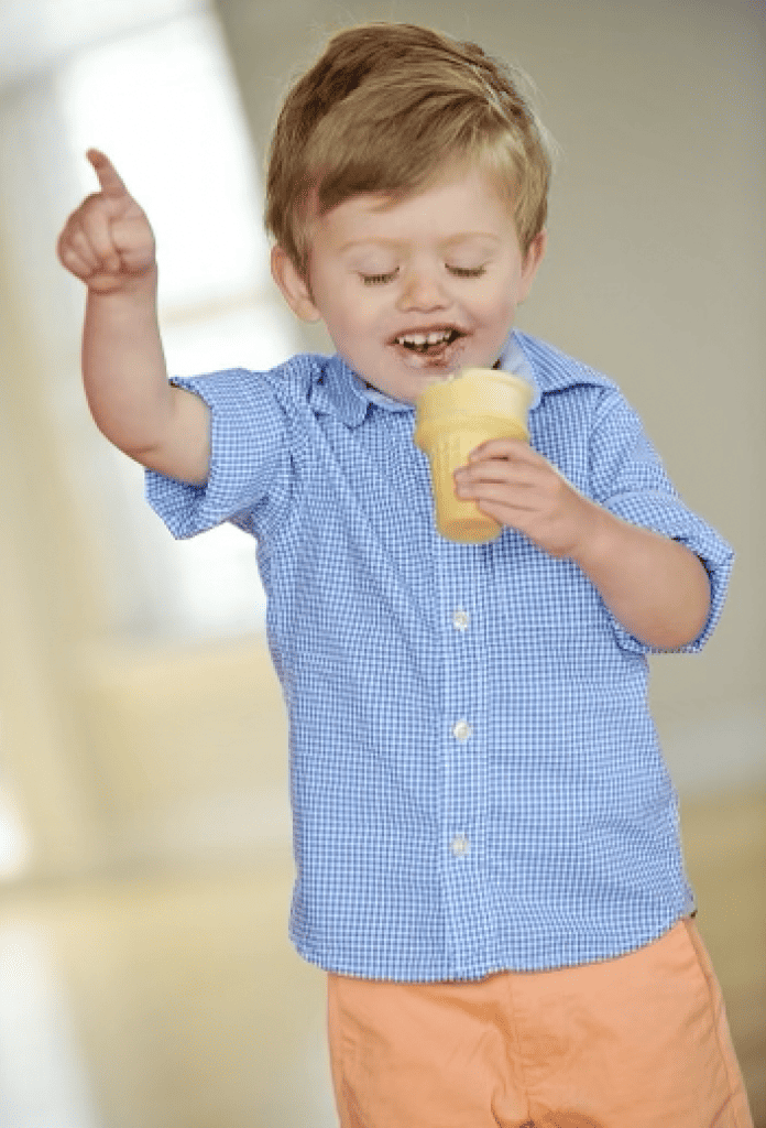 Toddler boy eating ice cream cone