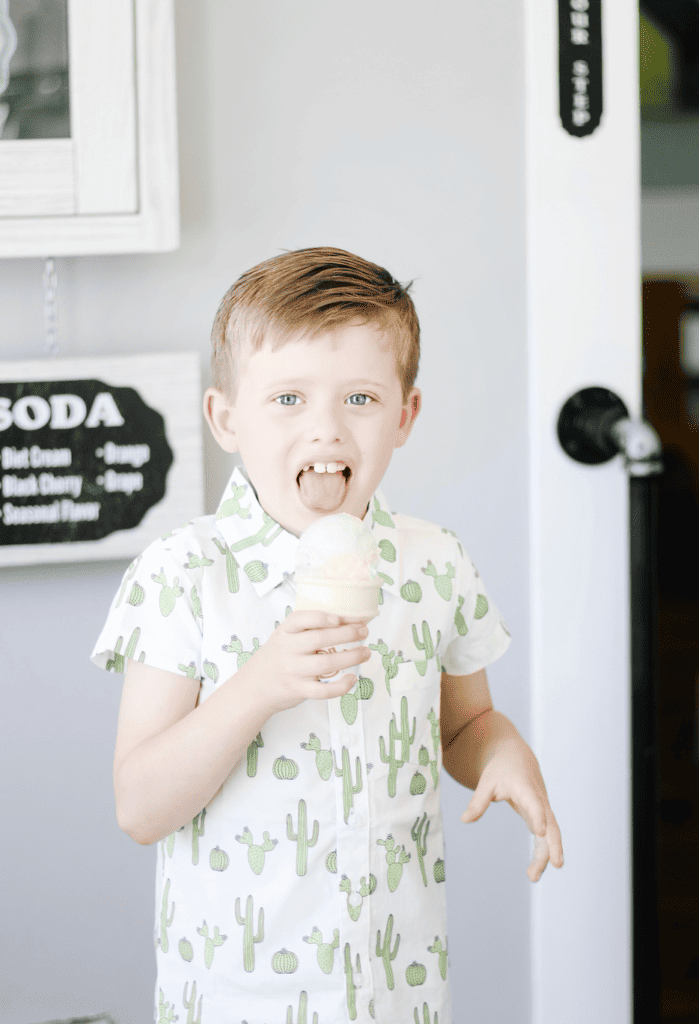 Little boy licking ice cream cone.