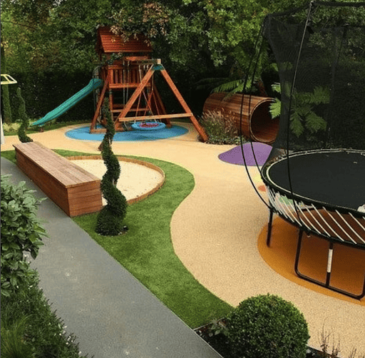 Backyard trampoline ideas include this entire playset, log tunnel, and trampoline that is complete for the ultimate kid backyard.