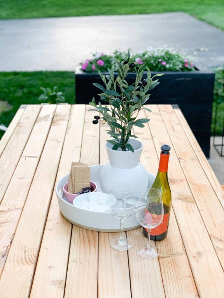 Outdoor table with wine glasses and smores