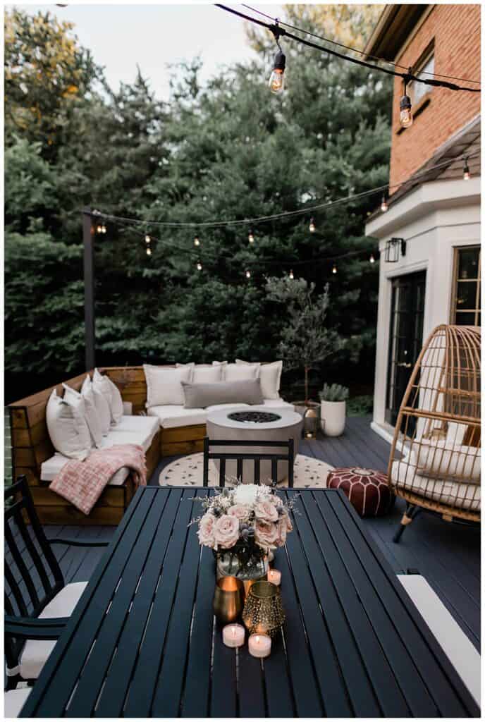 Beautiful deck with backyard fire pit placed surrounded by chairs.