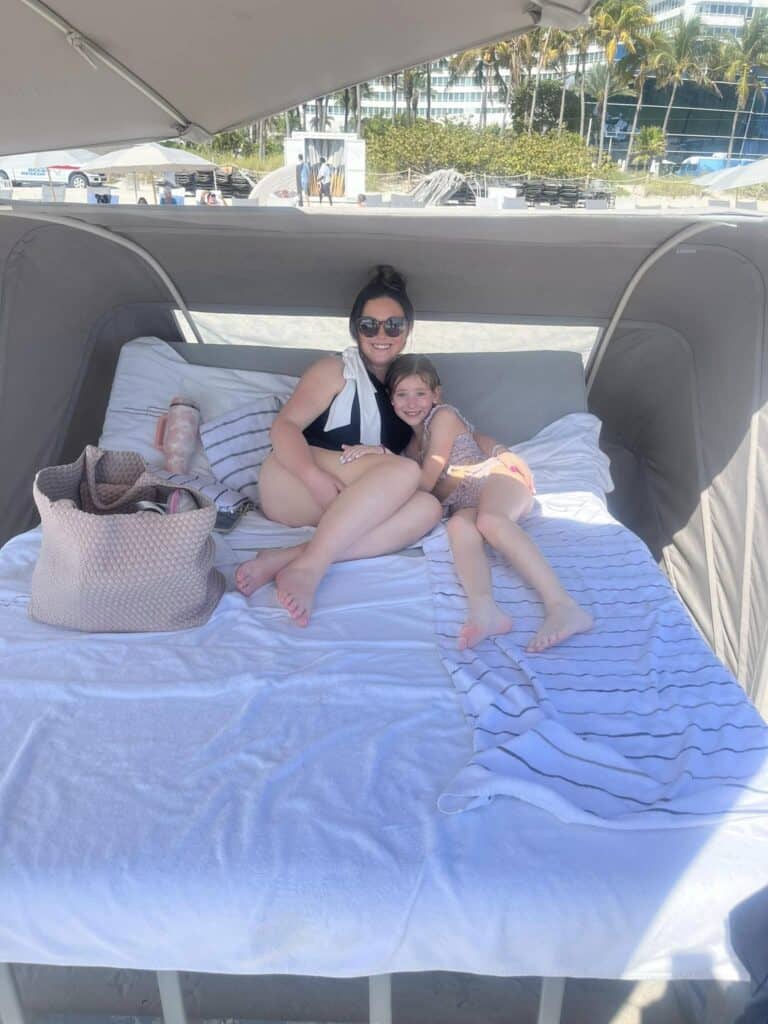 Best bags for moms can be taken all over including the pool with mom and daughter lounging on pool