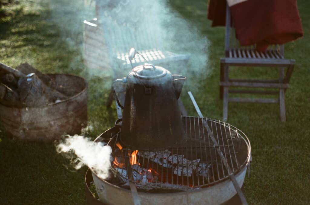 Close up of fire pit and tea kettle in a backyard 