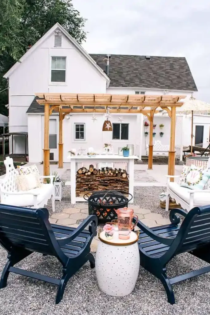 Create your own fire pit space in your backyard with a pergola and chairs.