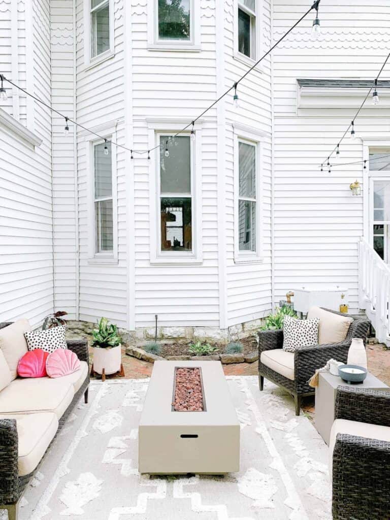 White wooden backyard patio steps leads to our historic 1800s brick pavers.