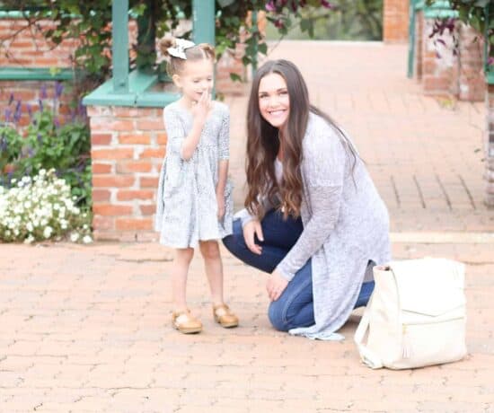 Best bags for moms is tote and backpack combo seen in this picture with mom and little girl