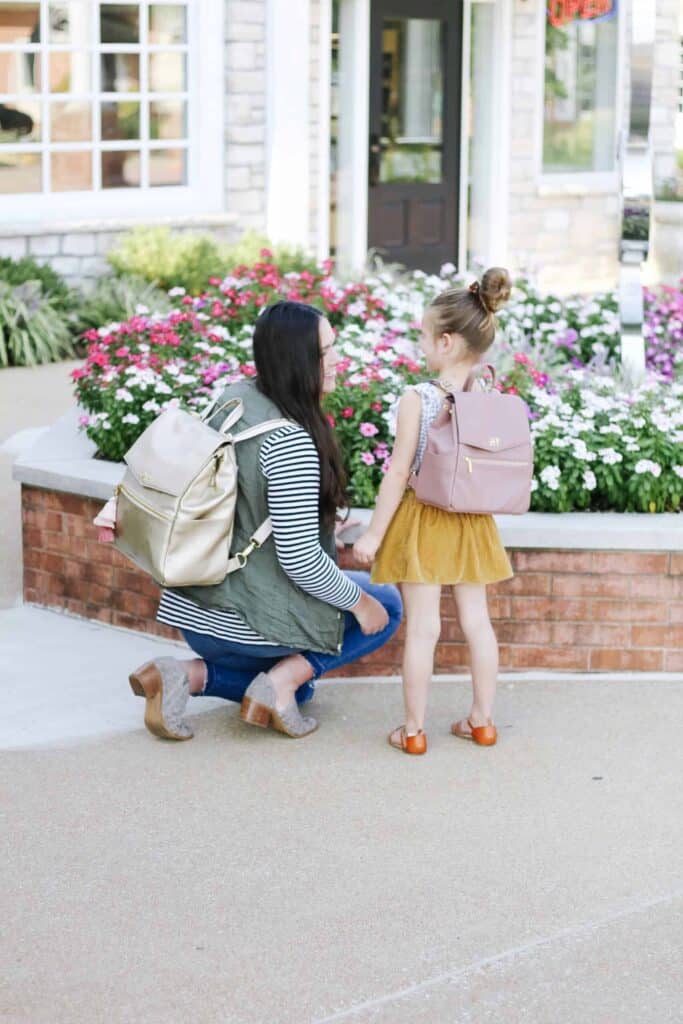Little girl with backpack and mom with best bags for moms.