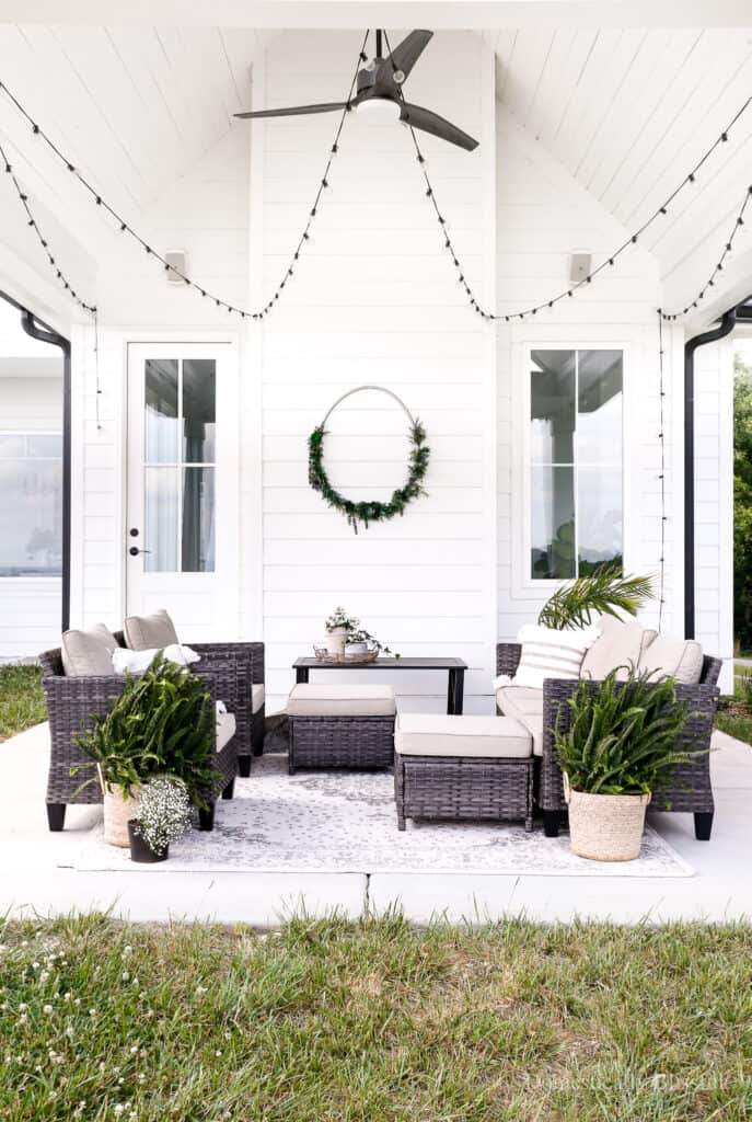 Simple concrete backyard patio steps leads to a small hang out spot.