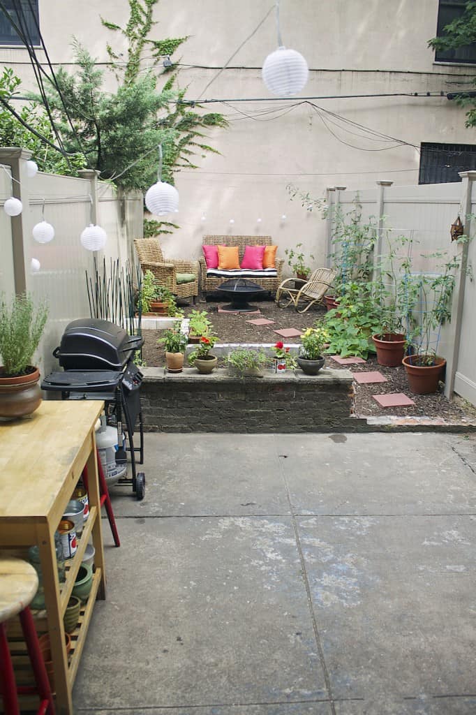 A city garden with a small fire pit area.