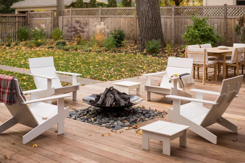 Where to put fire pit in backyard surrounded by wooden deck carved out space.