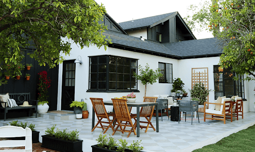 Patterned concrete backyard patio steps leads to a patio filled with texture and depth.