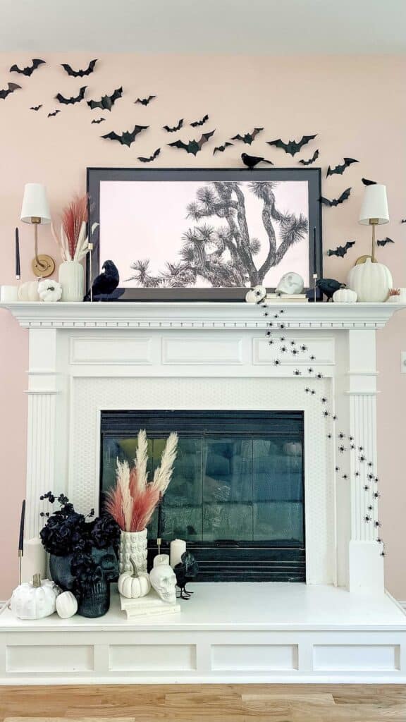 DIY Halloween Decorations on fireplace mantle filled with bats, vases, pumpkins