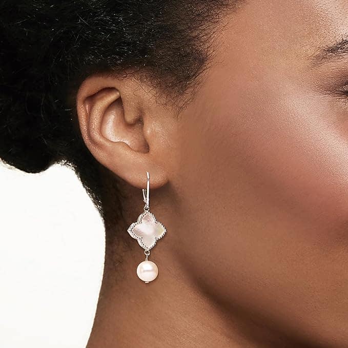 Beautiful drop pearl earrings on a model with crystals.