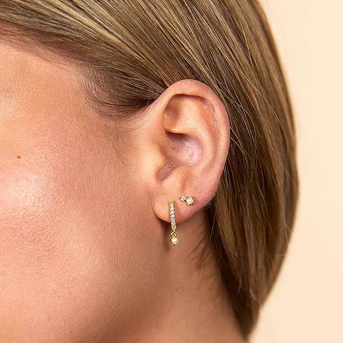 Hooped pearl earrings in a model's ear makes it appear there are two different earrings.