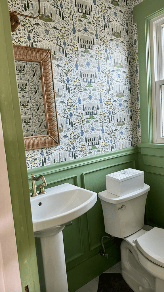 Green bathroom and wallpaper with woven mirror on amazon best sellers list