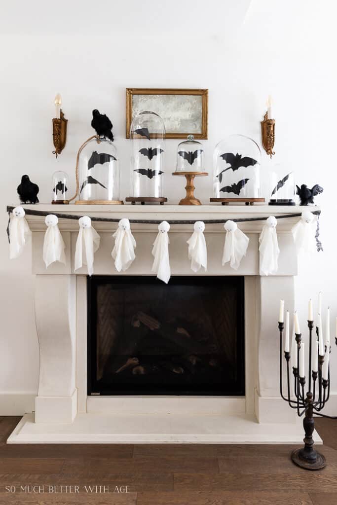 DIY Halloween Decorations ghost garland on fireplace mantle.