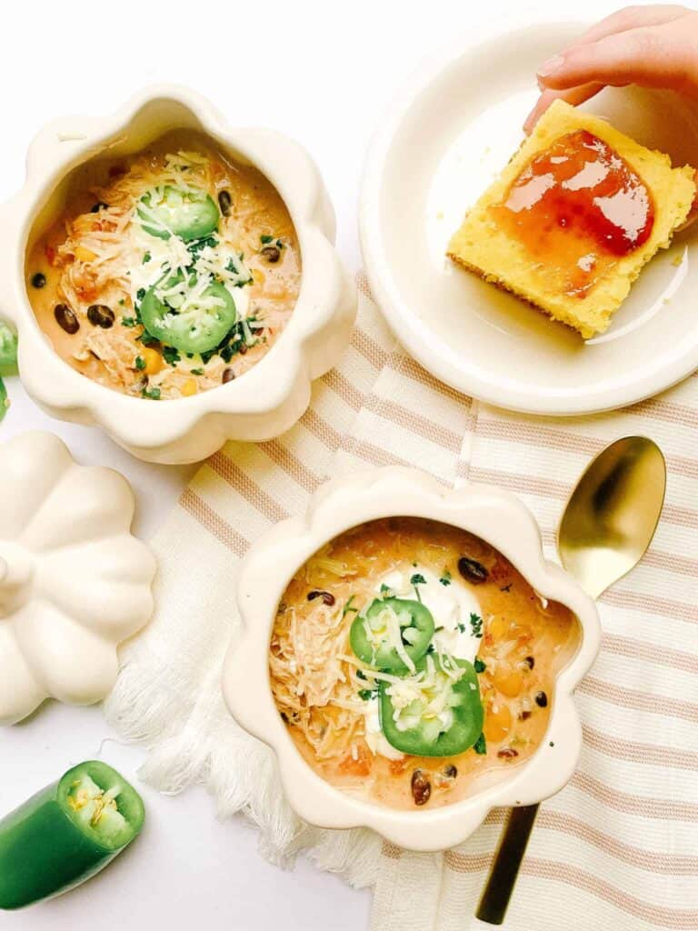 white chicken chili in pumpkin ceramic bowls and cornbread
