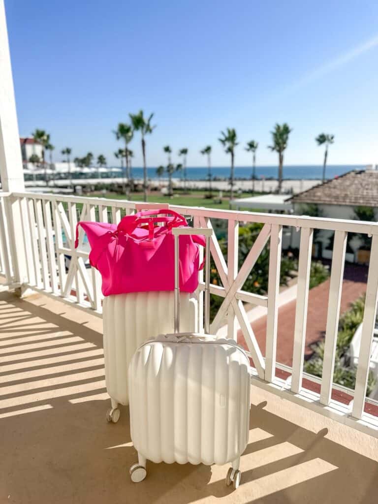 suitcases on a balcony with palm trees