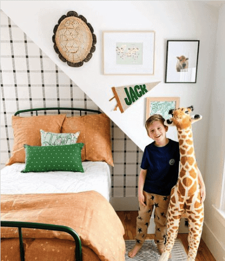 Boy in room with giraffe