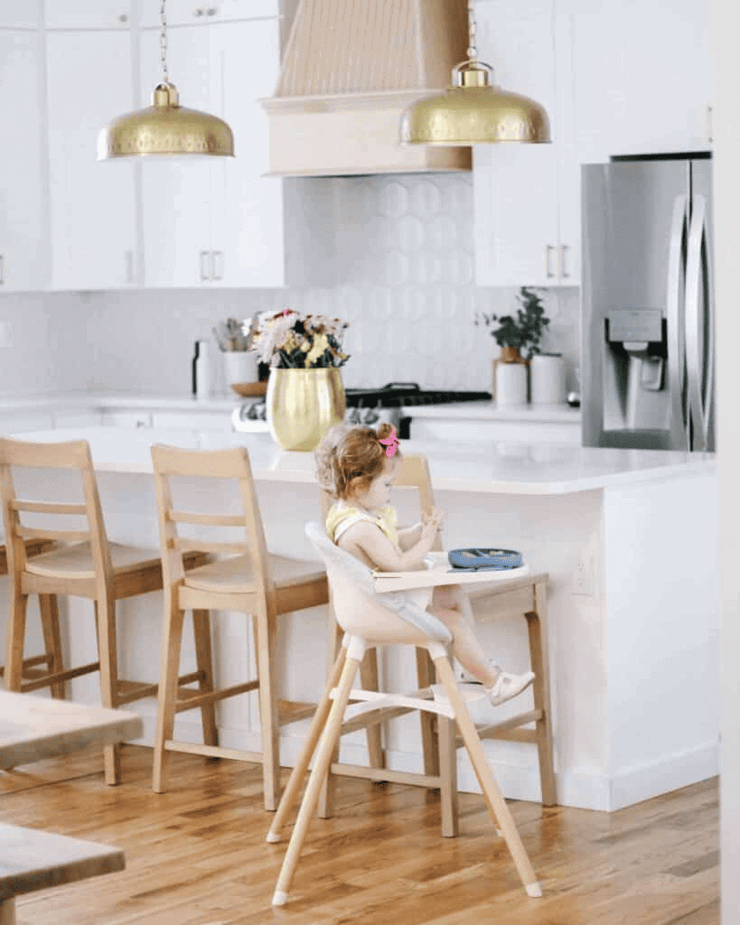 Baby in highchair in white kitchen