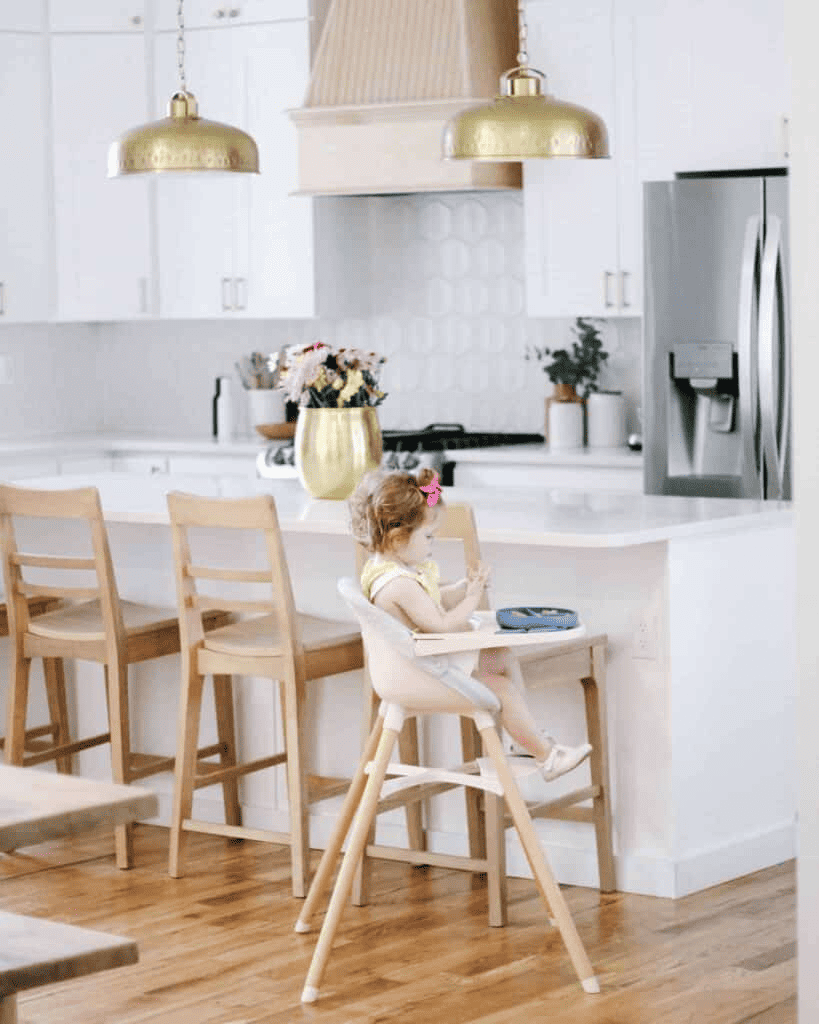 baby in high chair in white kitchen